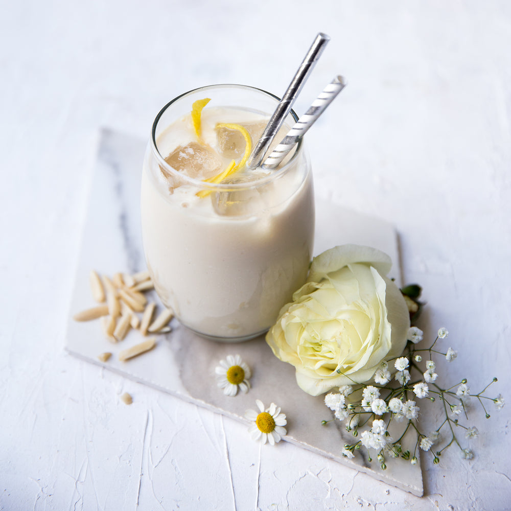 
                  
                    Load image into Gallery viewer, Herbalife Formula 1 vanilla shake with lemon zest and flowers, representing the Ultimate Healthy Breakfast Plan
                  
                