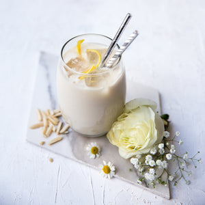 
                  
                    Load image into Gallery viewer, Herbalife Formula 1 vanilla shake with lemon zest and flowers, representing the Ultimate Healthy Breakfast Plan
                  
                
